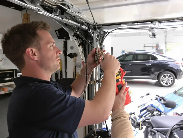 Medway Garage Door Repair safety certified technician performing cable replacement in Medway